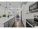 Spacious kitchen with a large island, granite countertops, stainless steel appliances, and hardwood floors at 3127 Pinehills Way, Mount Holly, NC 28120