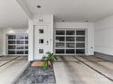 Welcoming entry with glass garage door, modern front door and neutral tones at 314 Viburnum Way Ct, Charlotte, NC 28208