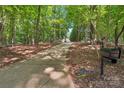 Long driveway leading to a stately home, surrounded by lush trees and greenery at 3327 Lakeside Dr, Charlotte, NC 28270