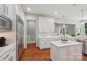 Modern white kitchen with stainless steel appliances and marble countertops at 3327 Lakeside Dr, Charlotte, NC 28270