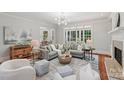Open living room with hardwood floors, large windows, and comfortable seating at 3327 Lakeside Dr, Charlotte, NC 28270