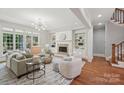 Bright living room featuring a fireplace, hardwood floors, and large windows at 3327 Lakeside Dr, Charlotte, NC 28270