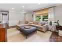 Bright living room featuring a large sectional sofa, stylish ottoman, and lots of natural light at 3530 Woodleaf Rd, Charlotte, NC 28205