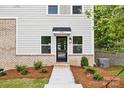 Modern townhome front entrance with brick accents, tidy landscaping, and a welcoming door at 3916 Hager Dr, Charlotte, NC 28208