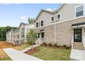Modern townhome exterior with brick facade, manicured landscaping, and inviting entrance at 3928 Hager Dr, Charlotte, NC 28208