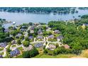 Aerial view showcases waterfront homes near a lake, surrounded by lush greenery and mature trees at 4431 1St Street Nw Dr, Hickory, NC 28601