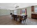 A dining room with fireplace, wood floors, and a view to the kitchen through the countertop at 5008 Social Cir, Fort Mill, SC 29707