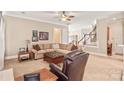 Open living room showing the staircase and featuring a comfortable seating arrangement at 8115 Wilburn Ct, Charlotte, NC 28277