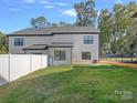Exterior of home featuring a wooden deck, fenced-in yard with lush green grass and privacy at 8315 Adrian Ct, Charlotte, NC 28270