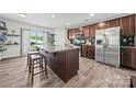 Modern kitchen featuring stainless steel appliances, granite countertops, and a functional center island with barstool seating at 8316 Waxhaw Hwy, Waxhaw, NC 28173