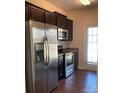 Well-equipped kitchen with stainless steel appliances and dark cabinets at 9170 Bradstreet Commons Way, Charlotte, NC 28215