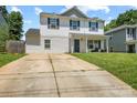 Charming two-story home with blue shutters and well-manicured lawn and long drive at 9612 Old Dowd Rd, Charlotte, NC 28214