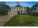 Charming two-story home with blue shutters and well-manicured lawn at 9612 Old Dowd Rd, Charlotte, NC 28214