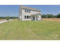 Expansive backyard featuring a lush green lawn, a covered patio, and ample space for outdoor activities at 102 Cartington Way # Haf0042, Mooresville, NC 28115
