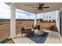 Relaxing covered patio featuring comfortable seating and a ceiling fan, perfect for enjoying the outdoors at 102 Cartington Way # Haf0042, Mooresville, NC 28115