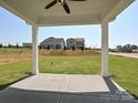 Covered patio with a concrete floor, providing a comfortable outdoor space with views of the well-maintained lawn at 102 Cartington Way # Haf0042, Mooresville, NC 28115