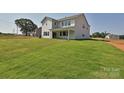 Expansive green backyard featuring a covered patio perfect for outdoor entertaining at 113 Tonbridge Way # Haf0031, Mooresville, NC 28115