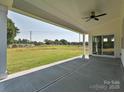 Covered patio overlooking a large grassy backyard with open views and fresh air at 113 Tonbridge Way # Haf0031, Mooresville, NC 28115