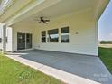 Covered patio with concrete flooring, ceiling fan, and views of the spacious backyard at 113 Tonbridge Way # Haf0031, Mooresville, NC 28115