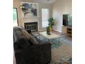 Inviting living room with a cozy fireplace, stylish decor, and a large window offering ample natural light at 11421 Kingfisher Dr, Charlotte, NC 28226