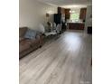 Bright and open living area with new vinyl floors, open kitchen, and dining area at 118 Fir St, McAdenville, NC 28101