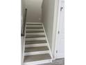 A well-lit staircase leads to the upper level of this inviting home at 118 Fir St, McAdenville, NC 28101
