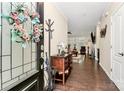 Inviting entryway features hardwood floors, fresh paint, and a decorative wreath, creating a warm and welcoming atmosphere at 12014 Belmont Mansion Dr, Charlotte, NC 28273