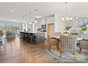 Open floor plan featuring a bright kitchen and a dining area with charming wicker chairs at 1216 Links Crossing Dr # 159, Monroe, NC 28112
