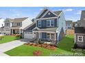 Beautiful two-story home with a well-maintained lawn and inviting curb appeal at 1216 Links Crossing Dr # 159, Monroe, NC 28112