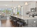 Bright kitchen featuring a large island with seating, stainless steel appliances, and an open layout at 1216 Links Crossing Dr # 159, Monroe, NC 28112