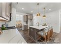 Stylish kitchen with a white quartz island, stainless steel appliances and hardwood floors at 1216 Links Crossing Dr # 159, Monroe, NC 28112