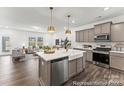 Modern kitchen featuring stainless steel appliances, gray cabinets, and a spacious island at 1216 Links Crossing Dr # 159, Monroe, NC 28112