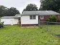 Spacious backyard showcasing green grass, a partial fence, and the rear view of the home at 1292 Longview Rd, Rock Hill, SC 29732