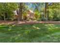 Charming two-story brick home with lush lawn and mature trees at 1520 Cureton Dr, Rock Hill, SC 29732