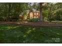 Charming two-story brick home with lush lawn and mature trees at 1520 Cureton Dr, Rock Hill, SC 29732