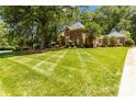 Well-manicured lawn and landscaping complement this brick two-story home at 1520 Cureton Dr, Rock Hill, SC 29732