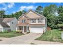 Charming two-story home featuring a stone facade, a covered front porch, and an attached two-car garage at 15203 Oldcorn Ln, Charlotte, NC 28262