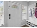 Bright entryway features a coat rack, bench, and laminate flooring at 15432 Coventry Court Ln, Charlotte, NC 28277