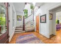 Charming foyer with hardwood floors, stairway, bench seat, and decorative art at 1801 E 8Th St, Charlotte, NC 28204