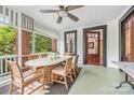 Relaxing screened porch features a dining table set and lovely views at 1801 E 8Th St, Charlotte, NC 28204