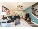 Open-concept living room features hardwood flooring, a large sectional sofa, and seamless access to the kitchen and staircase at 2045 13Th Ne St # 3, Hickory, NC 28601