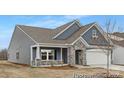 Stylish home showcasing modern architectural details, a covered porch, and manicured landscaping at 21011 Timber Tide Aly # 184, Lancaster, SC 29720
