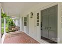 Inviting front porch with porch swing and stylish lighting fixtures creates a welcoming entrance at 227 Wingrave Dr, Charlotte, NC 28270