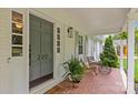 Charming front porch featuring stylish accents, comfortable seating and a welcoming open door at 227 Wingrave Dr, Charlotte, NC 28270