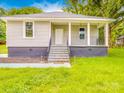 Inviting home featuring a covered porch with classic railings, enhancing curb appeal and outdoor enjoyment at 2440 Myers St, Gastonia, NC 28056