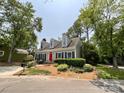 Well-maintained single-Gathering home with dormer windows, manicured landscaping, and a vibrant red front door at 2619 Quailrush Rd, Charlotte, NC 28226