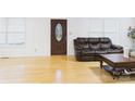 Bright living room with hardwood floors, large windows and dark leather furniture at 3055 16Th Ne St, Hickory, NC 28601