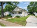 Charming home with a covered front porch, decorative railings, and landscaped front yard at 330 Central Ave, Kannapolis, NC 28081