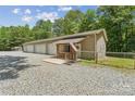 Three-car garage boasts ample parking space and an inviting covered porch with a decorative American flag at 364 Luther Dr, Iron Station, NC 28080