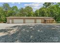 Exterior view of a three-car garage with a covered porch, offering convenient parking and curb appeal at 364 Luther Dr, Iron Station, NC 28080